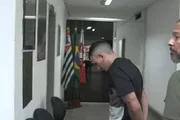 Douglas Alves da Silva arriving at the police station after custody hearing
