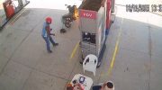 Motorcycle catches fire at gas station and employee's quick action prevents tragedy