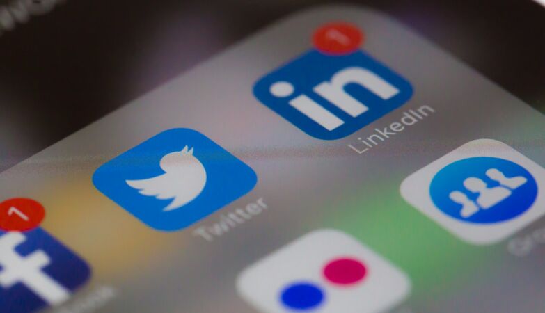 A cell phone with social networks installed, such as Twitter and LinkedIn