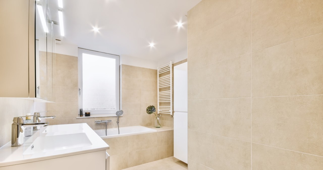 You don't have to cuff the bathroom. Just stick it on the tiles