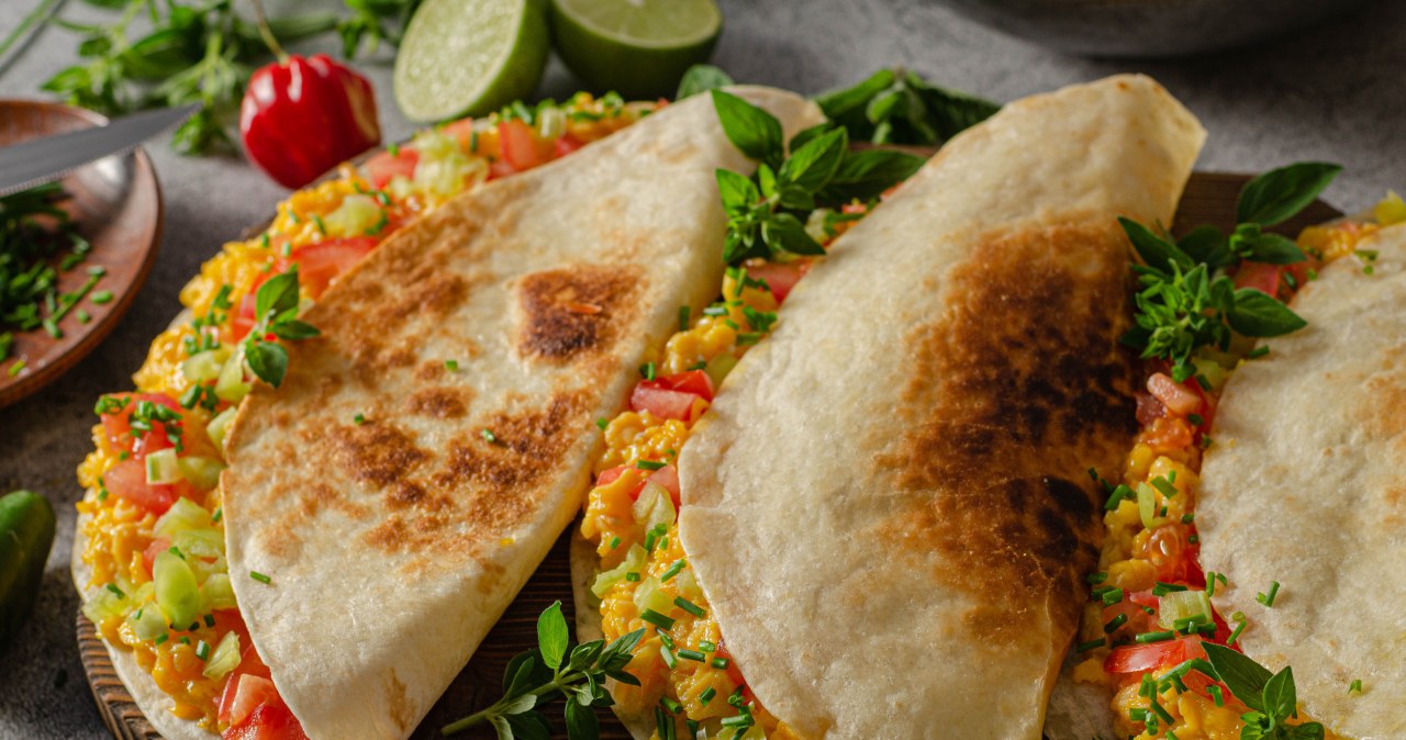Scrambled eggs in a tortilla with vegetables. Mexican style breakfast idea