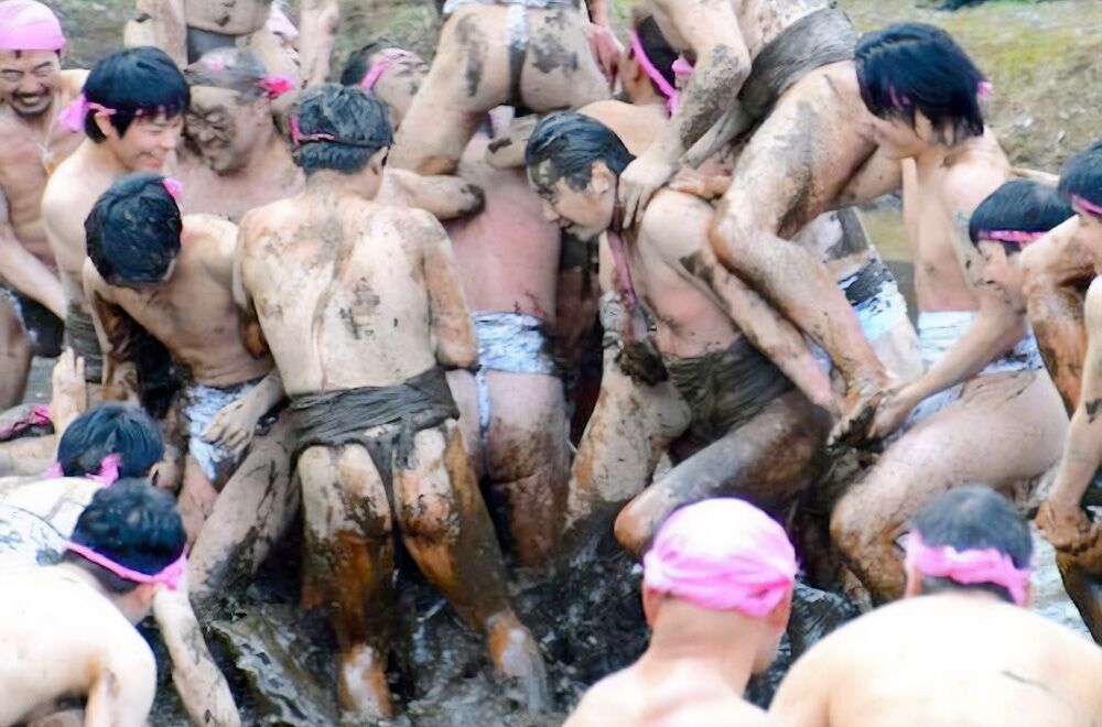 Men in loincloths wrestle in the mud in a bizarre harvest ritual. It's Saint John of Japan
