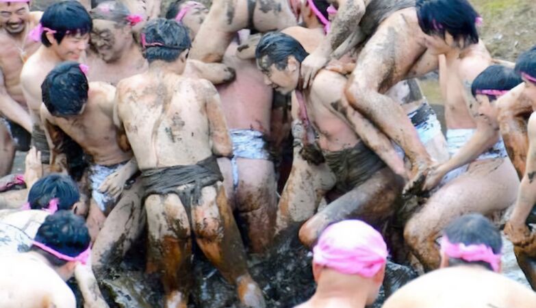 Men in loincloths wrestle in the mud in a bizarre harvest ritual. It's Saint John of Japan