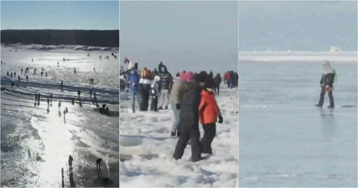 People walk and skate on the frozen sea on a beach in Poland
