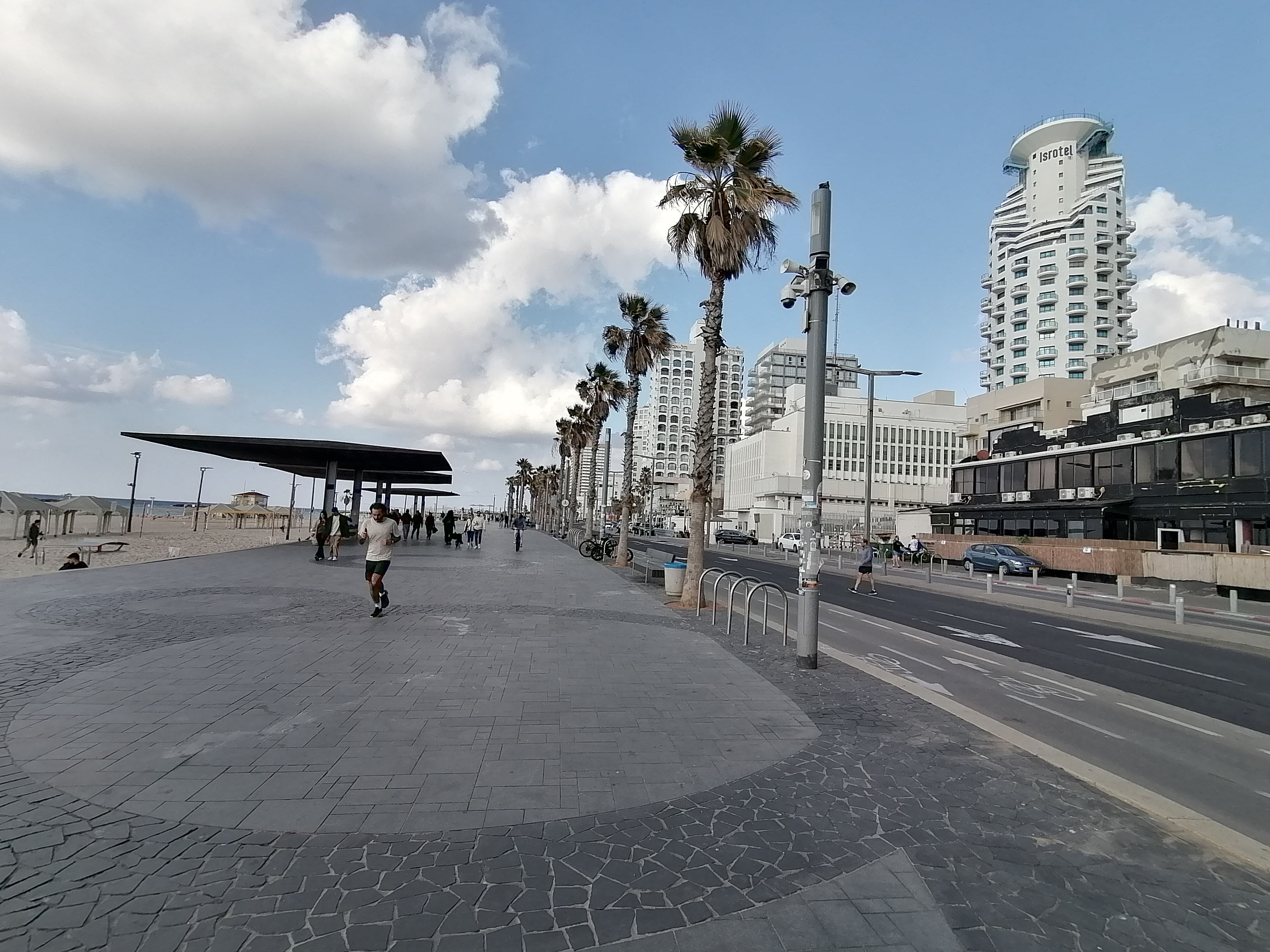 'Life must go on': Rackets, sunbathing and alarms on Tel Aviv beach
