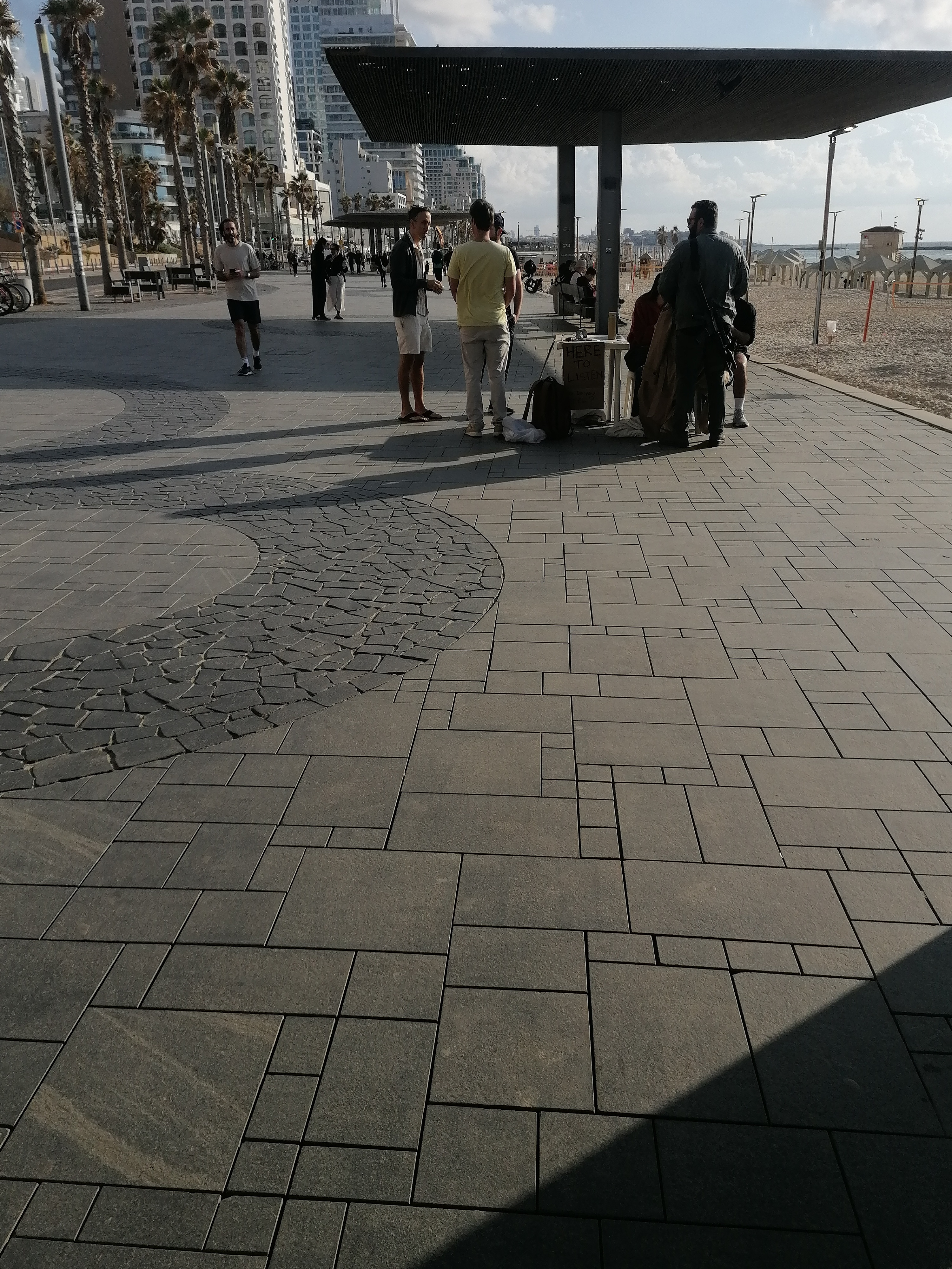 'Life must go on': Rackets, sunbathing and alarms on Tel Aviv beach