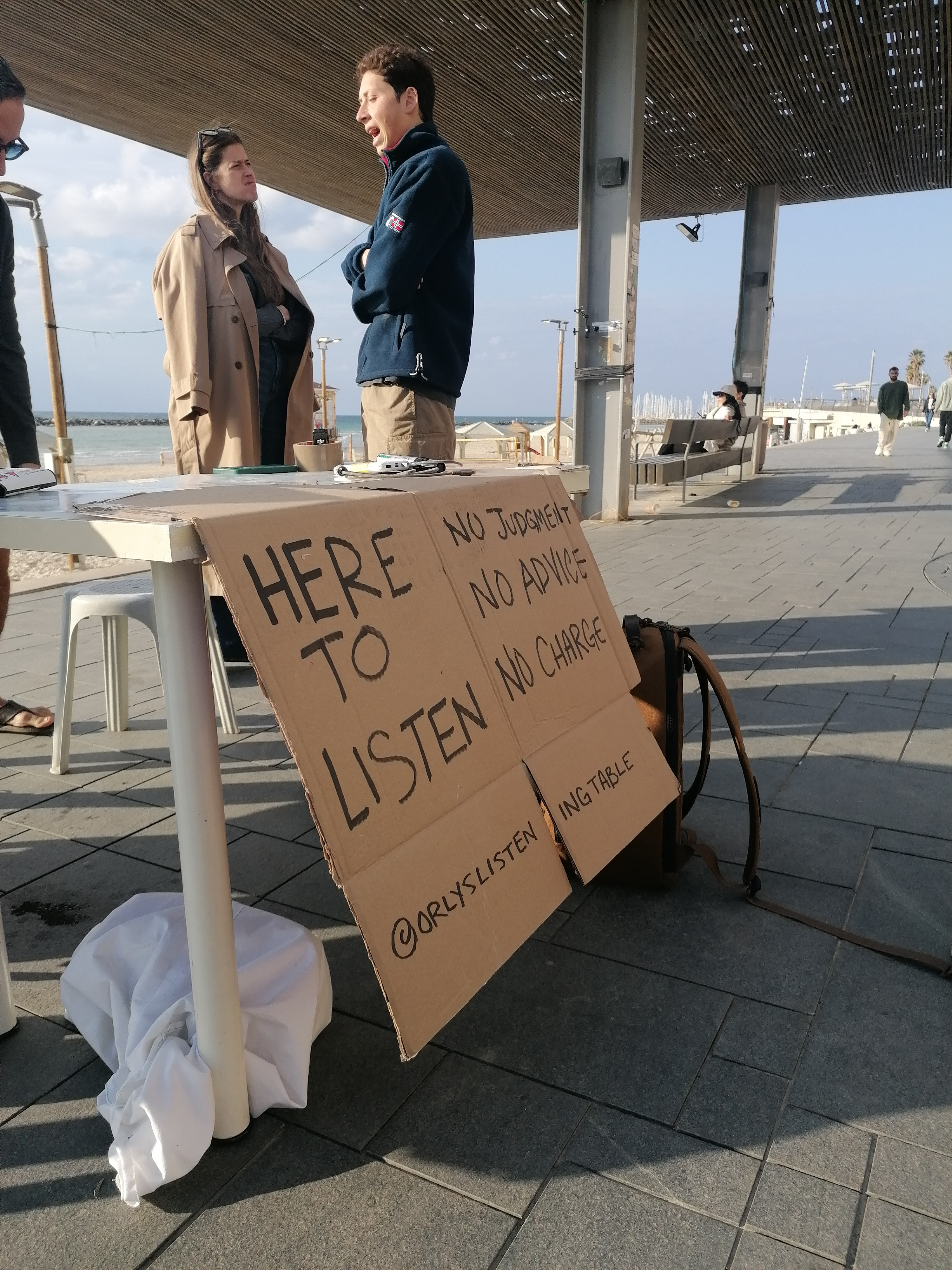 'Life must go on': Rackets, sunbathing and alarms on Tel Aviv beach