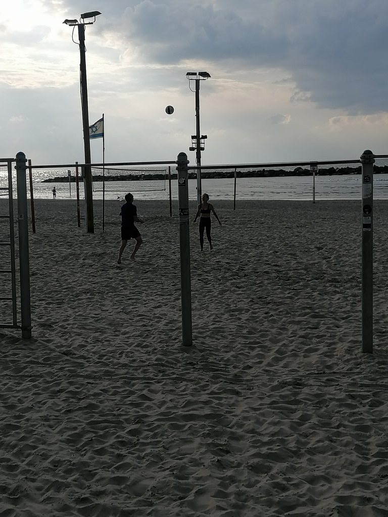 'Life must go on': Rackets, sunbathing and alarms on Tel Aviv beach