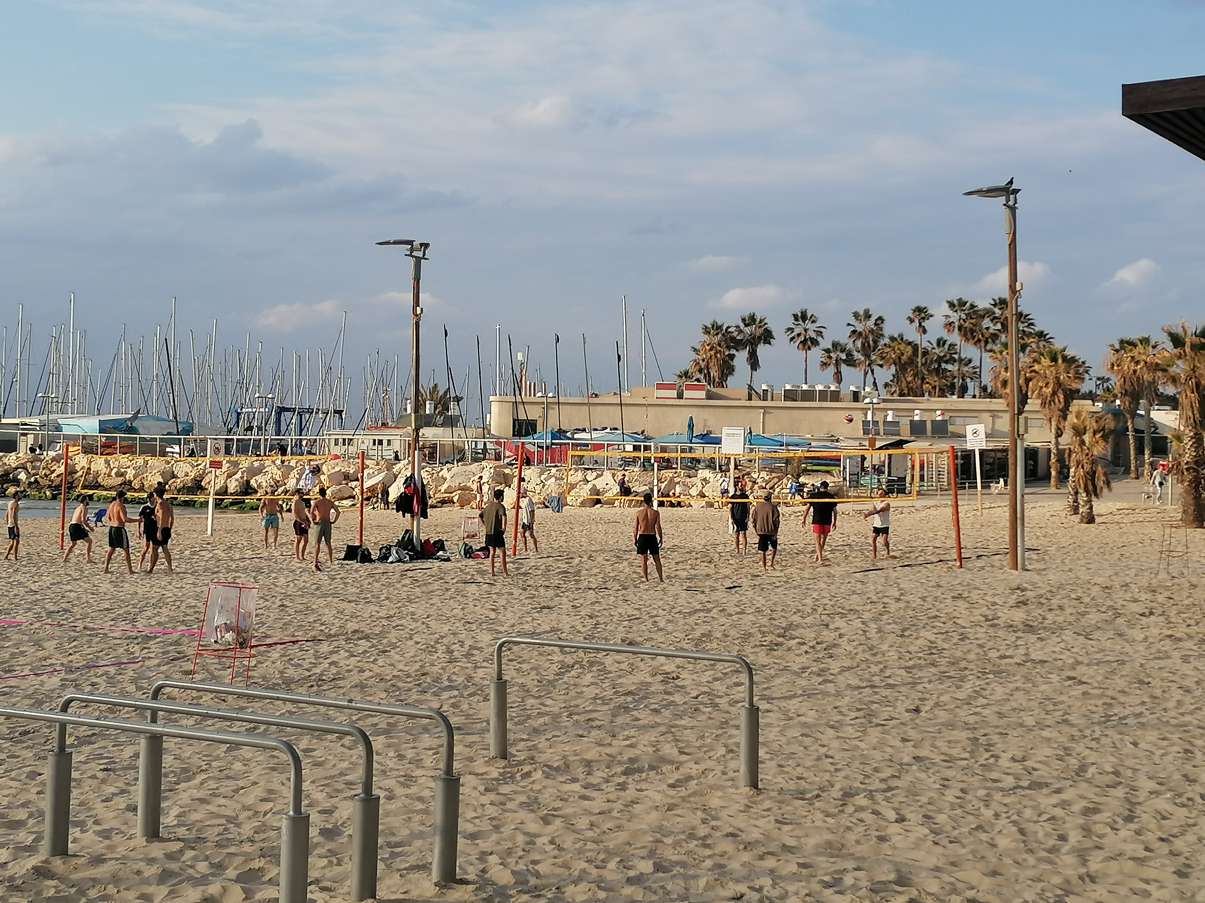'Life must go on': Rackets, sunbathing and alarms on Tel Aviv beach