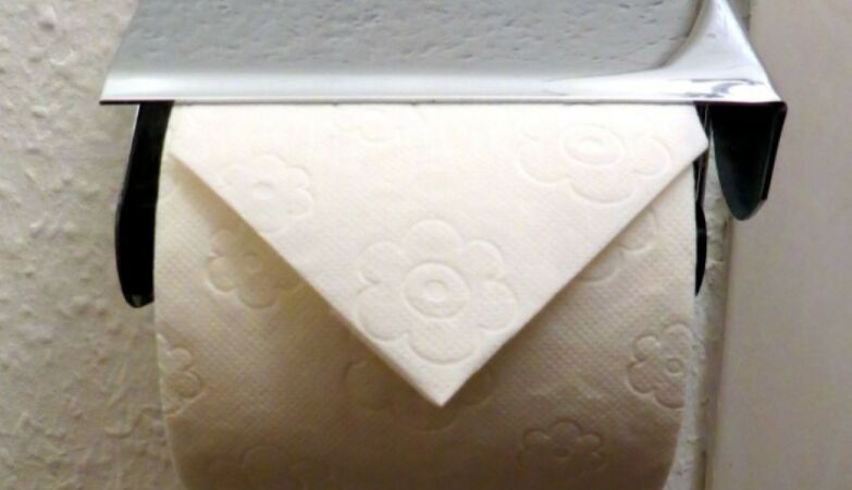 Why is toilet paper in hotels folded into a triangle?