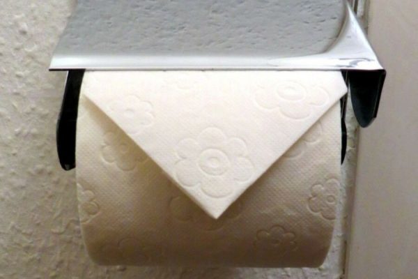 Why is toilet paper in hotels folded into a triangle?