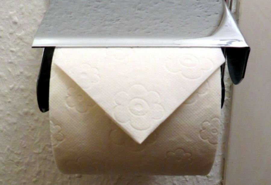 Why is toilet paper in hotels folded into a triangle?