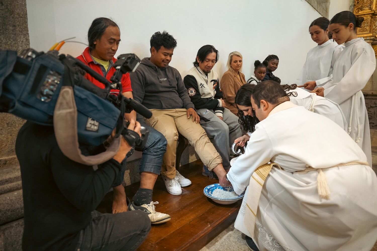 All 12 people at the footwash are immigrants. Because “we are all brothers”