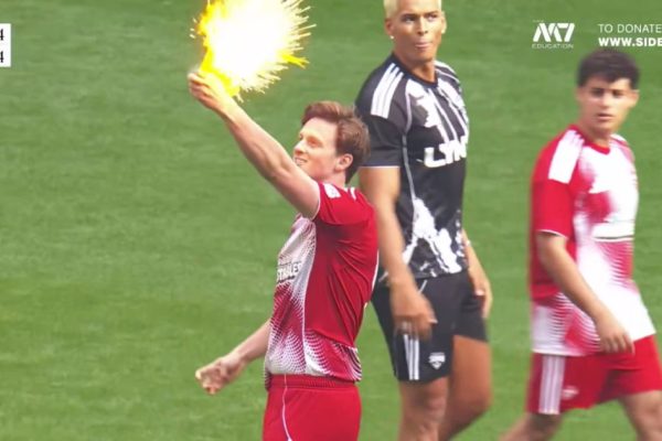 Max Fosh takes the referee's yellow card and burns it at Wembley