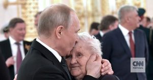 Putin brings flowers to a reunion in Moscow with one of the most influential women in his life