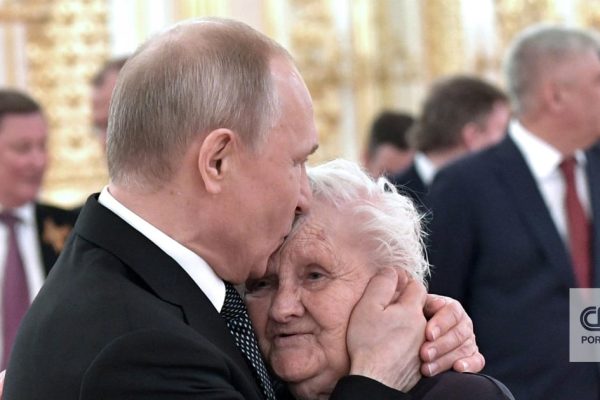 Putin brings flowers to a reunion in Moscow with one of the most influential women in his life