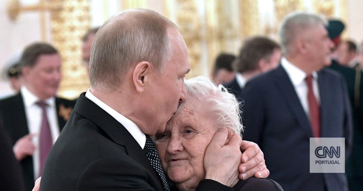 Putin brings flowers to a reunion in Moscow with one of the most influential women in his life