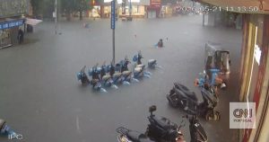 The moment a woman is saved from drowning in the middle of a flood in China